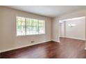 Bright living room features hardwood floors, neutral paint, and a large window with natural light at 5911 Christopher Ln, Lithonia, GA 30058