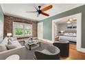 Cozy living room featuring exposed brick wall, ceiling fan, and view to a bedroom at 960 Taft Ne Ave # 9, Atlanta, GA 30309