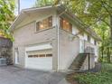 Beige brick home with attached garage and mature trees at 1583 Nantahalla Ne Ct, Atlanta, GA 30329