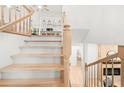 View of the staircase with wooden railings and a glimpse of the living room and kitchen at 1583 Nantahalla Ne Ct, Atlanta, GA 30329