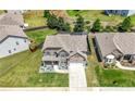 Birds-eye view of two-story house with two-car garage, landscaping, and backyard in a neighborhood with green lawns at , Atlanta, GA 30349