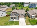 Aerial view of a two-story home with a stone and brick facade, two-car garage, and a well-manicured front yard at , Atlanta, GA 30349