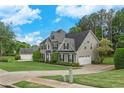 A beautifully landscaped yard complements this home with a detached garage and neutral color palette at 225 Ruby Forest Pkwy, Suwanee, GA 30024