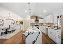 Bright kitchen featuring white cabinets, quartz countertops, a vaulted ceiling, and an open floor plan at 2541 Peyton Woods Sw Trl, Atlanta, GA 30311