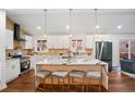 Modern kitchen featuring a quartz island, stainless steel appliances and pendant lighting with an open floorplan at 2541 Peyton Woods Sw Trl, Atlanta, GA 30311