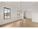 Bright living room with large windows, hardwood floors, and elegant trim details at 5424 Gallagher Ct, Powder Springs, GA 30127