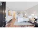 Bright main bedroom with modern decor, wood-look floors, and ensuite bathroom at 1150 Collier Nw Rd # D20, Atlanta, GA 30318