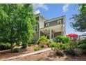 Beautiful home exterior showcasing the back porch and patio area, surrounded by lush landscaping at 2434 Soft Maple St, Atlanta, GA 30360