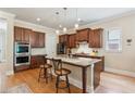 Well-equipped kitchen with a large island, dark wood cabinets, and stainless steel appliances at 2434 Soft Maple St, Atlanta, GA 30360