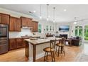Open-concept kitchen featuring an island with seating, granite countertops, and stainless steel appliances at 2434 Soft Maple St, Atlanta, GA 30360