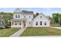 Beautifully built two-story home with gray siding, black roof, and a cozy front porch at 4060 Andover Cir, Mcdonough, GA 30252