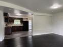 Open concept view of the living room into the updated kitchen with hardwood floors at 5460 Huron Dr, Morrow, GA 30260