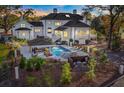 Aerial view of backyard with pool, waterfall, and outdoor dining area perfect for entertaining at 1445 Hillside Dr, Grayson, GA 30017