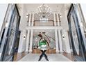 Spacious two story foyer with staircase, chandelier, and hardwood floors at 1445 Hillside Dr, Grayson, GA 30017