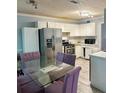 Bright eat-in kitchen with stainless steel appliances, white cabinets, and tile flooring, perfect for Gathering meals at 320 Orleans Blvd, Mcdonough, GA 30253