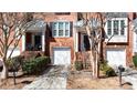 Attractive brick townhome showcasing attached garages and landscaped front yards at 4766 Longcourt Se Dr # 23, Atlanta, GA 30339