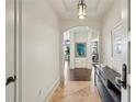 Elegant foyer with tile flooring, decorative lighting, and art leading to open living spaces at 2700 Paces Ferry Se Rd # 202, Atlanta, GA 30339