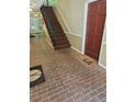 Brick entryway with a staircase and a brown door with a decorative rug at 3142 Reeves Se St, Smyrna, GA 30080