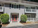 Condominium building with gray siding and red double-door entrance at 3142 Reeves Se St, Smyrna, GA 30080