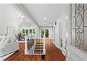 Inviting foyer with gleaming hardwood floors, a skylight, and decorative glass front door at 413 Sassafras Rd, Roswell, GA 30076