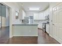 Bright kitchen featuring white cabinets, stainless steel appliances, and granite countertops at 5335 Lexington View Pl, Sugar Hill, GA 30518