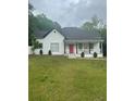 Attractive home featuring a classic front porch, neat landscaping, and a vibrant red door at 6860 Parkway Dr, Lithonia, GA 30058