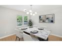 Bright dining room features a modern light fixture, marble table, and large windows at 789 Third St, Stone Mountain, GA 30083