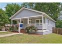Delightful house with a covered porch, vibrant landscaping, and a well-maintained lawn at 789 Third St, Stone Mountain, GA 30083