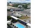 Aerial view of the condo building with a pool and highway, showcasing the urban surroundings at 1280 W Peachtree Nw St # 2409, Atlanta, GA 30309