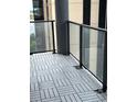 Balcony featuring neutral pavers and glass panels, providing a sleek and modern outdoor space at 1280 W Peachtree Nw St # 2409, Atlanta, GA 30309