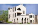 Stunning new construction home with a white brick exterior, arched entry, and a second-story balcony and awning at 215 Rolison Way, Fayetteville, GA 30214