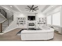 Bright living room with custom built-ins, fireplace, and elegant white sectional sofa at 481 Saddle Ridge Dr, Lawrenceville, GA 30046