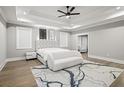 Serene main bedroom with tray ceilings, plush rug, and a stylish upholstered headboard at 481 Saddle Ridge Dr, Lawrenceville, GA 30046