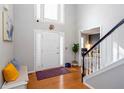 Inviting foyer with a soaring ceiling, hardwood floors, and bench seating by the front door at 58 Parkside Cir, Marietta, GA 30068