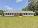 Beautiful ranch-style home with a covered front porch and lush green lawn at 70 Heritage Way, Covington, GA 30016
