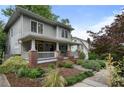 A side view of a beautifully landscaped two-story home with a cozy front porch at 1066 High Point Ne Dr, Atlanta, GA 30306