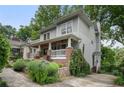 Two-story home with inviting front porch, showcases its curb appeal and charming neighborhood setting at 1066 High Point Ne Dr, Atlanta, GA 30306
