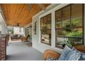 Inviting front porch with wood ceiling, comfortable seating, and natural light for relaxing outdoors at 1066 High Point Ne Dr, Atlanta, GA 30306