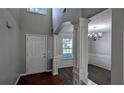 Open entryway with views of dining room featuring elegant chandelier and large window at 2153 Pine View Trl, Ellenwood, GA 30294
