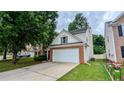 Well-kept home features a driveway, brick details, and green lawn at 2153 Pine View Trl, Ellenwood, GA 30294