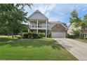 Charming two-story home with a well-manicured lawn and inviting front porch at 251 Parc Dr, Canton, GA 30114