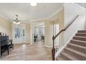 Welcoming foyer with wood floors, chandelier lighting, and staircase, creating a grand entrance at 251 Parc Dr, Canton, GA 30114