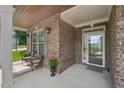Inviting front porch with brick accents and comfortable seating, perfect for enjoying the outdoors at 251 Parc Dr, Canton, GA 30114