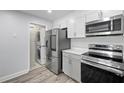 Kitchen area featuring stacked washer and dryer, stainless steel refrigerator, and modern appliances at 2657 Lenox Ne Rd # A-5, Atlanta, GA 30324