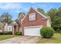 Lovely brick home with attached two car garage, neat lawn and bushes at 3185 Highgreen Trl, Atlanta, GA 30349