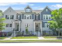 Charming townhomes with gray and white brick, black trim, fenced yards, and well-manicured landscaping at 2744 Bell Se Dr, Smyrna, GA 30080