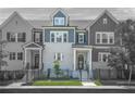 Charming townhomes with gray and white brick, black trim, fenced yards, and well-manicured landscaping at 2744 Bell Se Dr, Smyrna, GA 30080