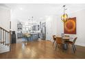 Open-concept living space with an island kitchen featuring stainless appliances and an adjacent dining area at 2744 Bell Se Dr, Smyrna, GA 30080