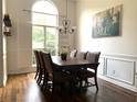 Dining room with a large window, elegant wood trim, and a spacious dining table set for six at 2945 Dogwood Creek Parkway, Duluth, GA 30096