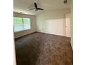 Spacious bedroom featuring ceiling fan, plush carpet, and large window at 1700 Devon Sw Dr, Atlanta, GA 30311